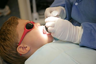 Child gets fluoride varnish applied to teeth