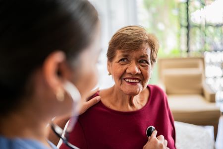 Woman listens to heartbeat of patient