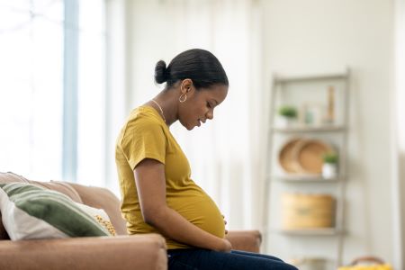 Pregnant woman sitting on couch