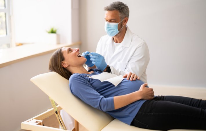 Pregnant woman patient receives dental care