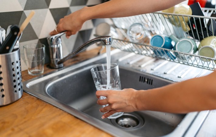 Person fills up cup with water