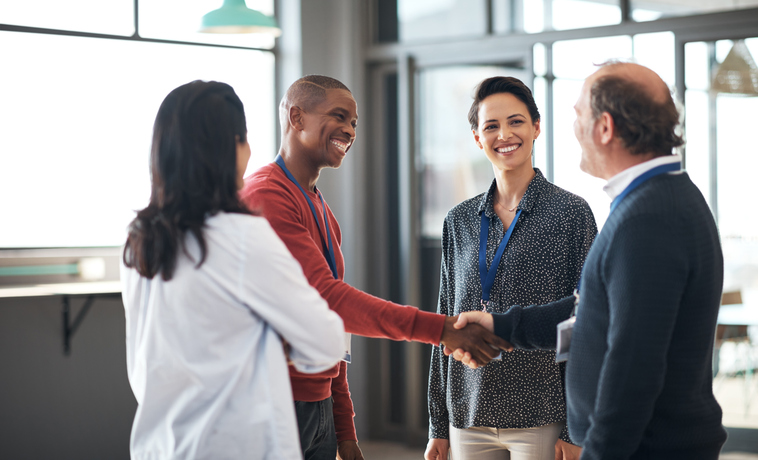 Shot of a group of businesspeople networking at a conference