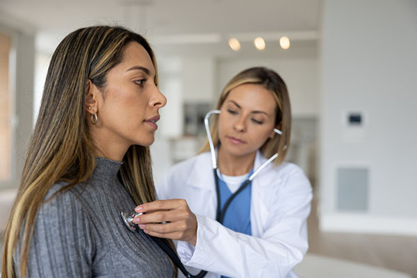 Doctor on a house call performing a medical exam